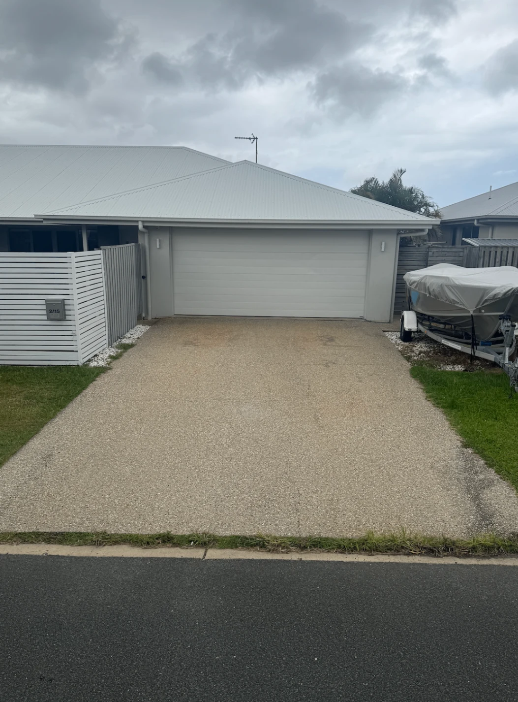 Exposed aggregate driveway before pressure cleaning